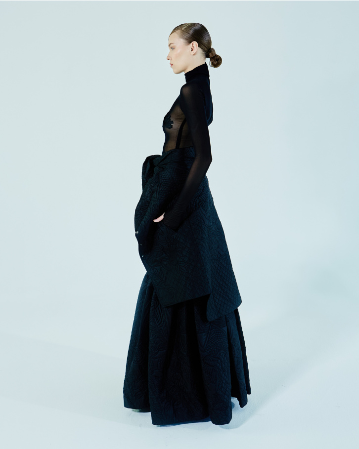 Black turtleneck bodysuit, quilted long skirt and blazer