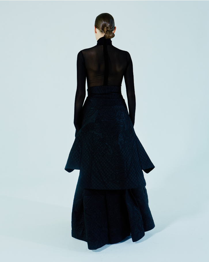 Black turtleneck bodysuit, quilted long skirt and blazer