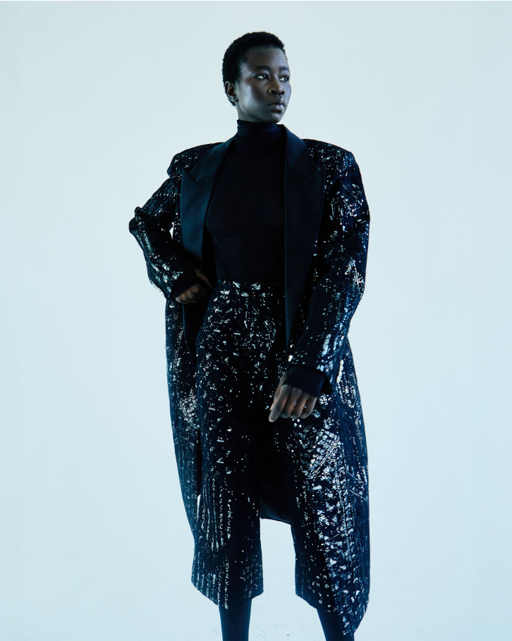 Black sheer turtleneck bodysuit with silver jacket and pants