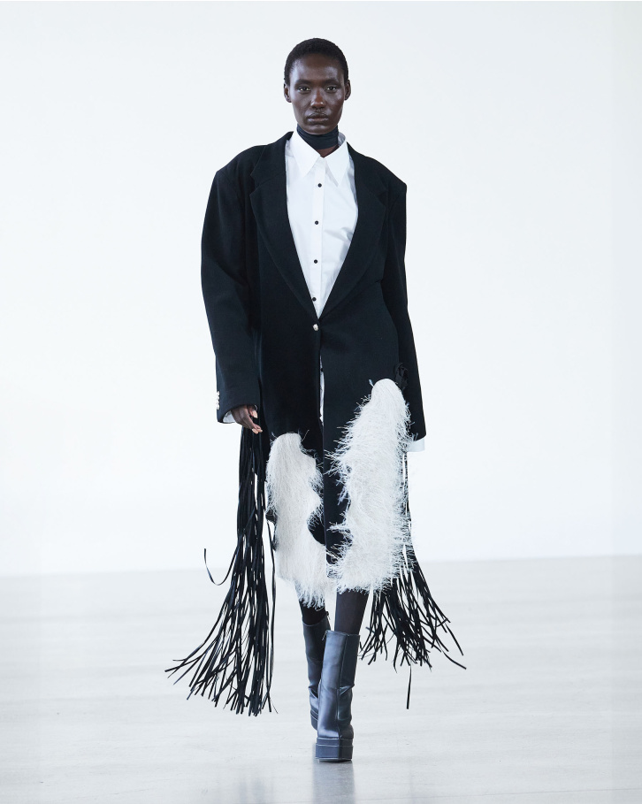 Black single-buttoned trench coat and white shirt