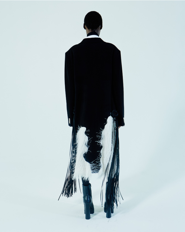 Black single-buttoned trench coat and white shirt