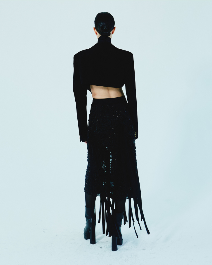 Black fringed skirt with bralette and short jacket