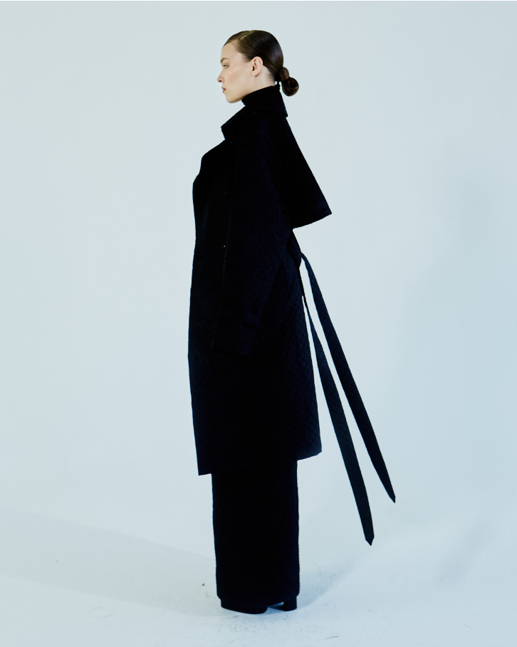Black quilted jumpsuit with trench coat