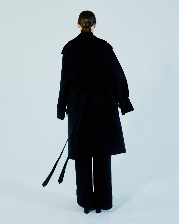 Black quilted jumpsuit with trench coat