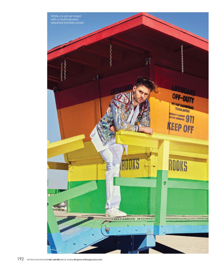 White co-ord set styled with a multicoloured, sequined bomber jacket