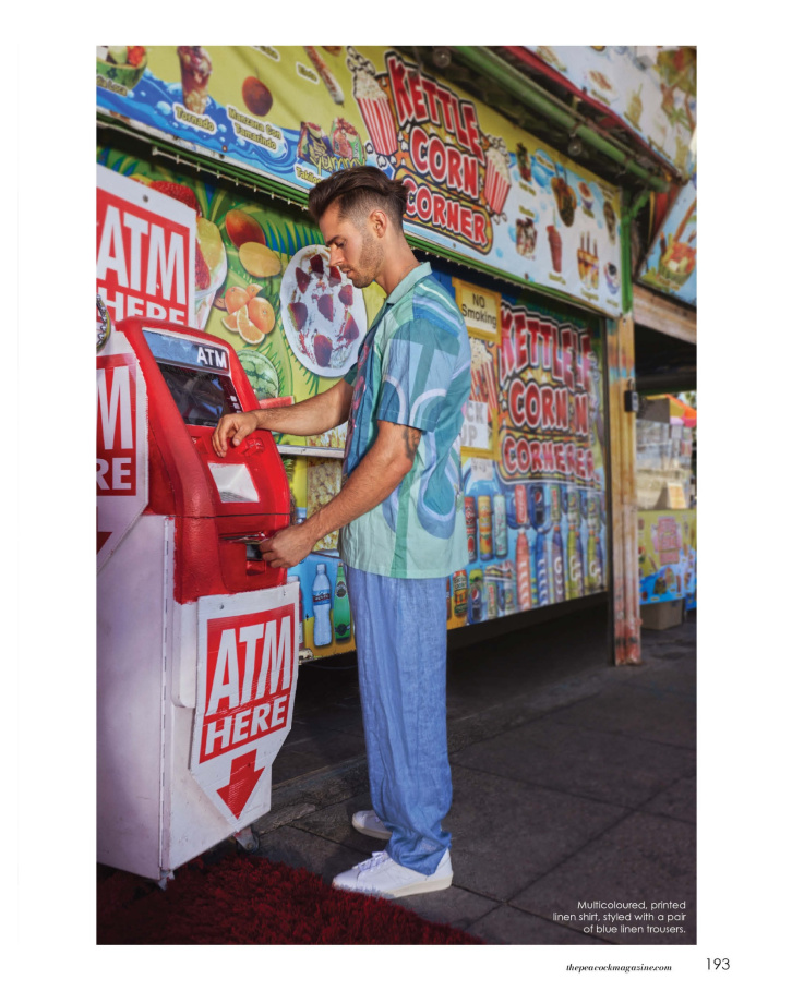 Multicoloured, printed linen shirt, styled with a pair of blue linen trousers