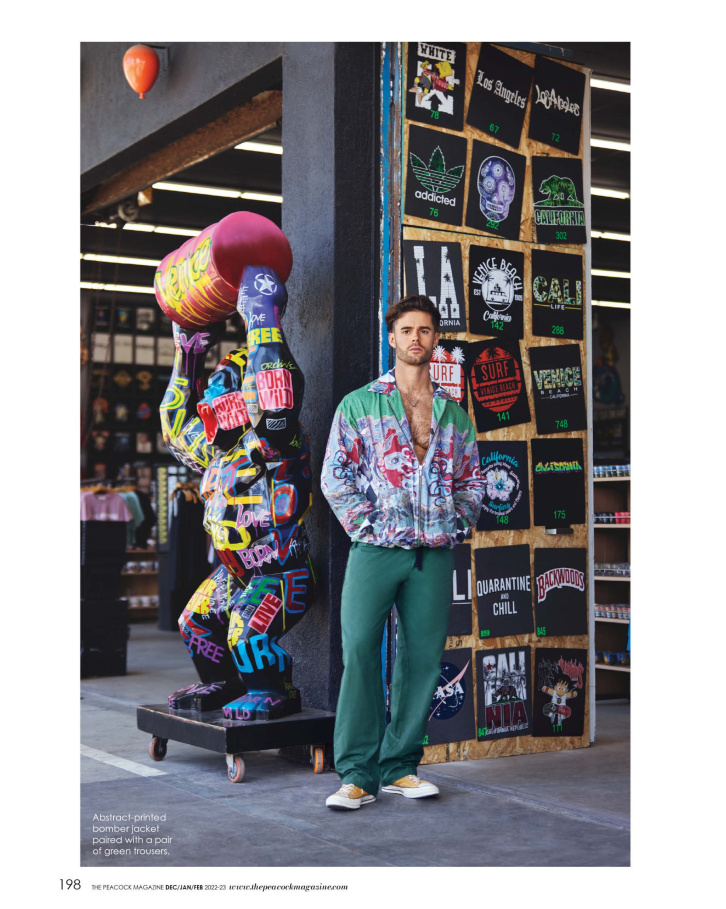 Abstract-printed bomber jacket paired with a pair of green trousers