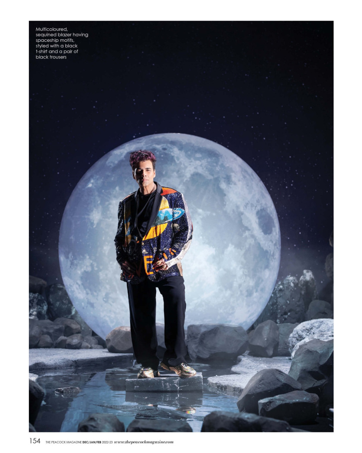 Multicoloured, sequined blazer having spaceship motifs, styled with a black t-shirt and a pair of black trousers