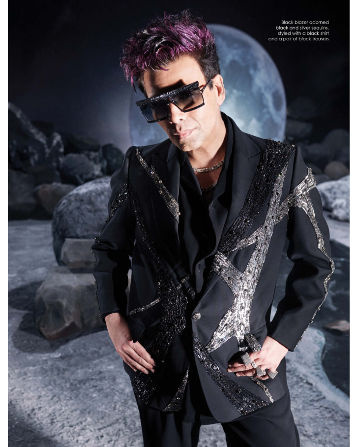 Black blazer adorned black and silver sequins, styled with a black shirt and a pair of black trousers