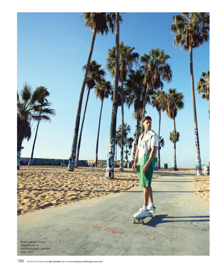 Forest green shorts paired with a multicoloured, printed linen shirt