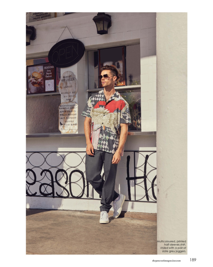 Multicoloured, printed half-sleeves shirt, styled with a pair of slate grey joggers.