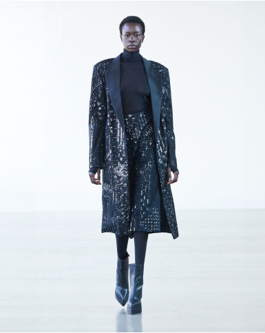 Black sheer turtleneck bodysuit with silver jacket and pants
