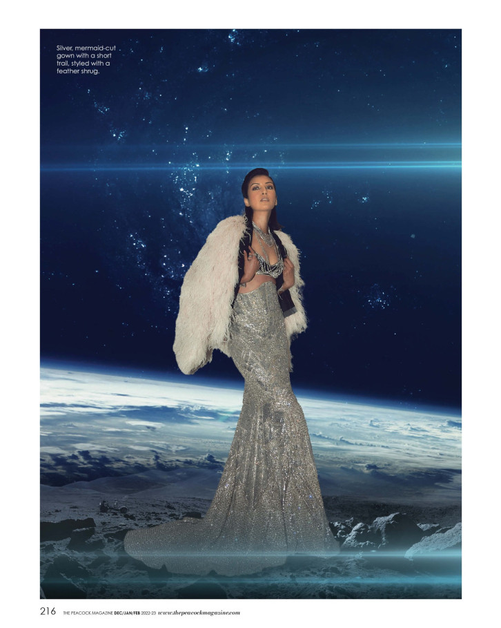 Silver, mermaid-cut gown with a short trail, styled with a feather shrug